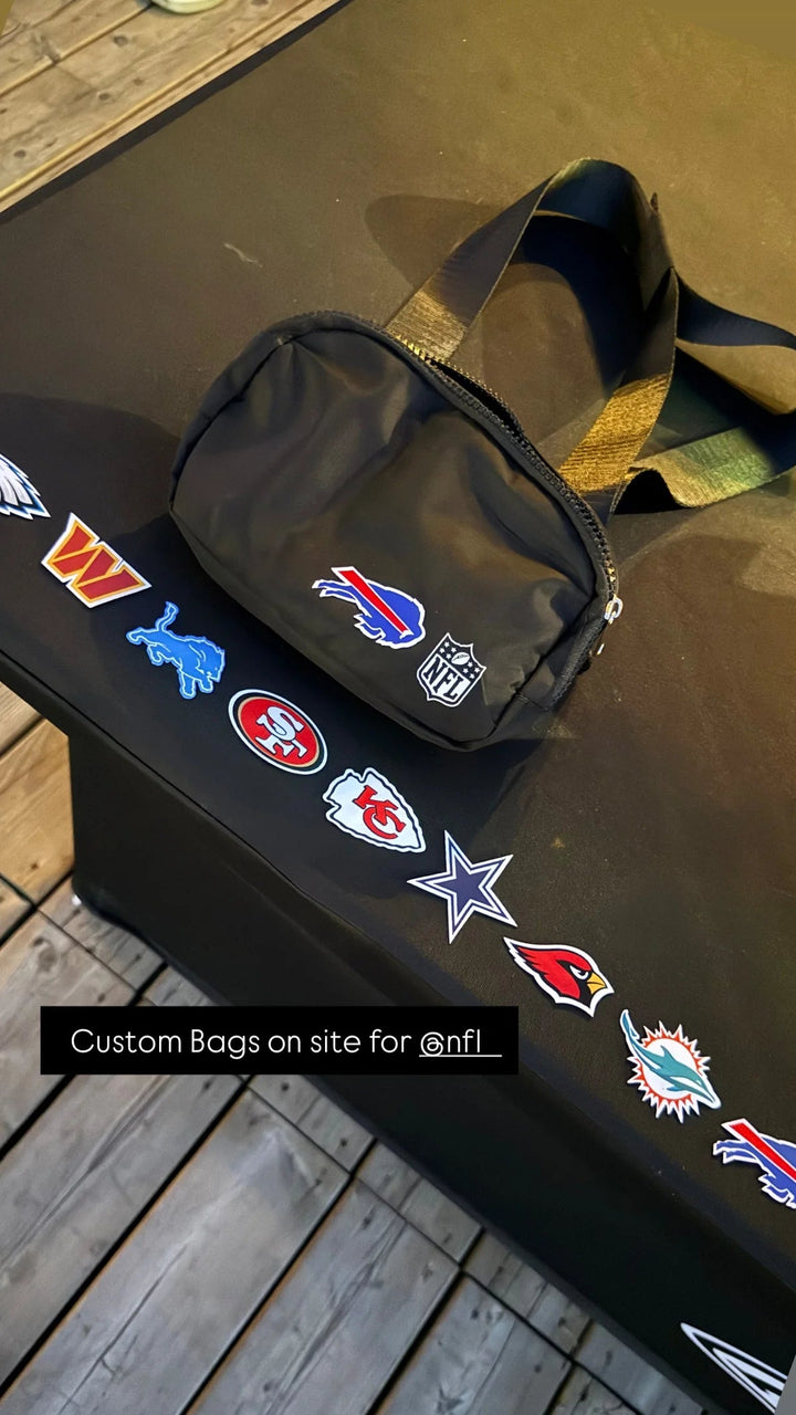 A side bag beside a selection of team-logo tags