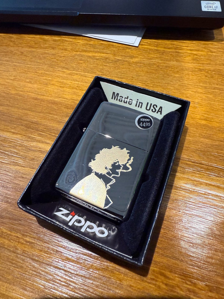 Black lighter with a gold silhouette portrait laser-engraved on the front