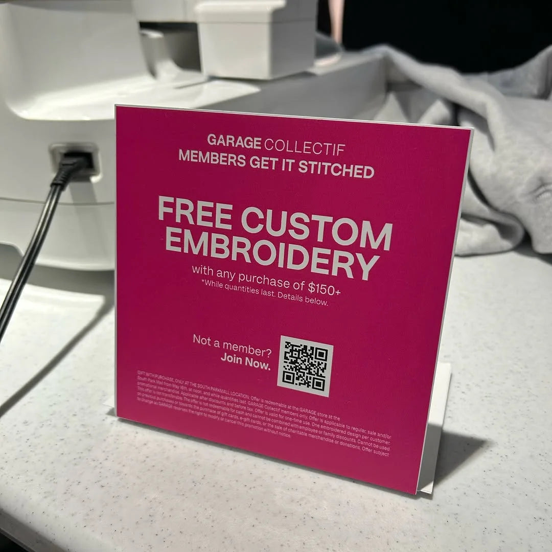 “Free custom embroidery” sign in store