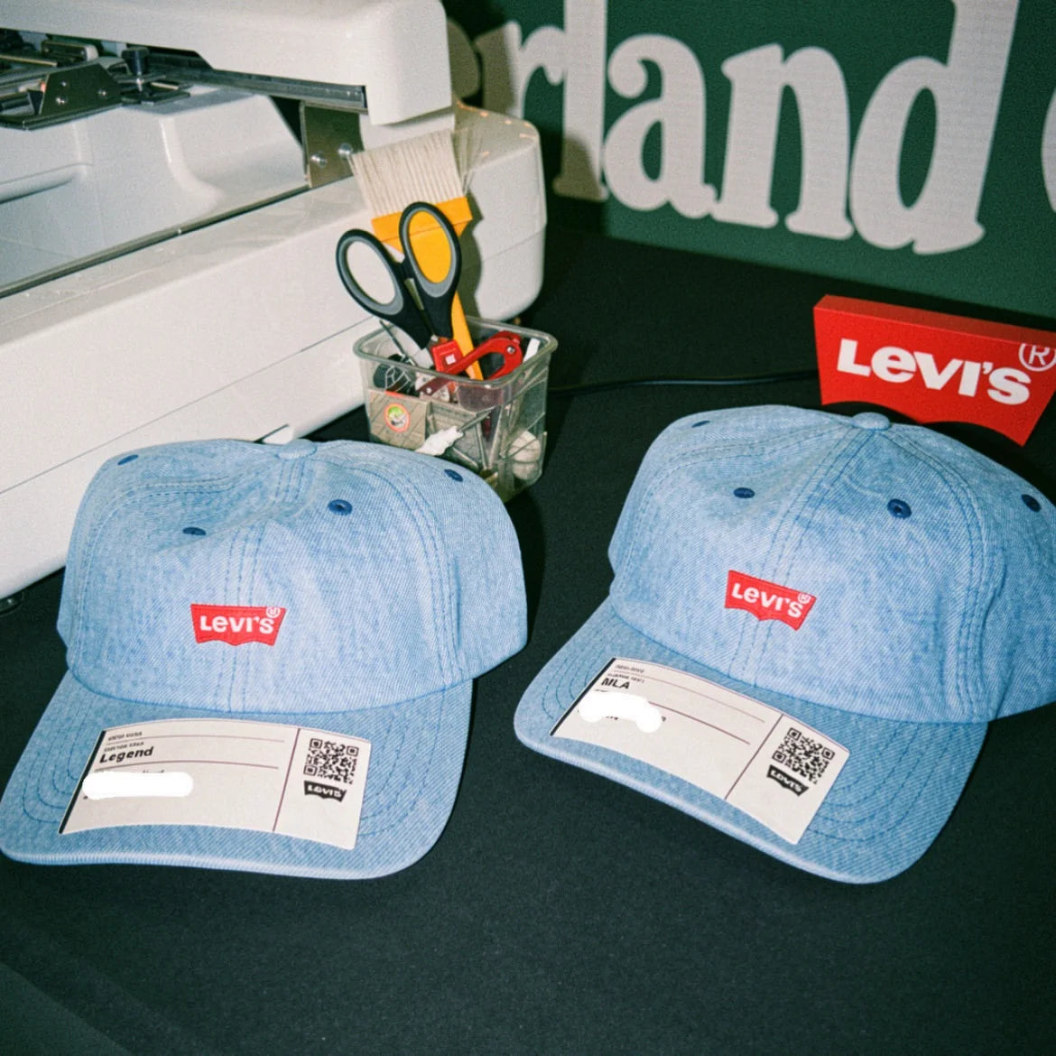 Levi’s denim caps beside the embroidery machine