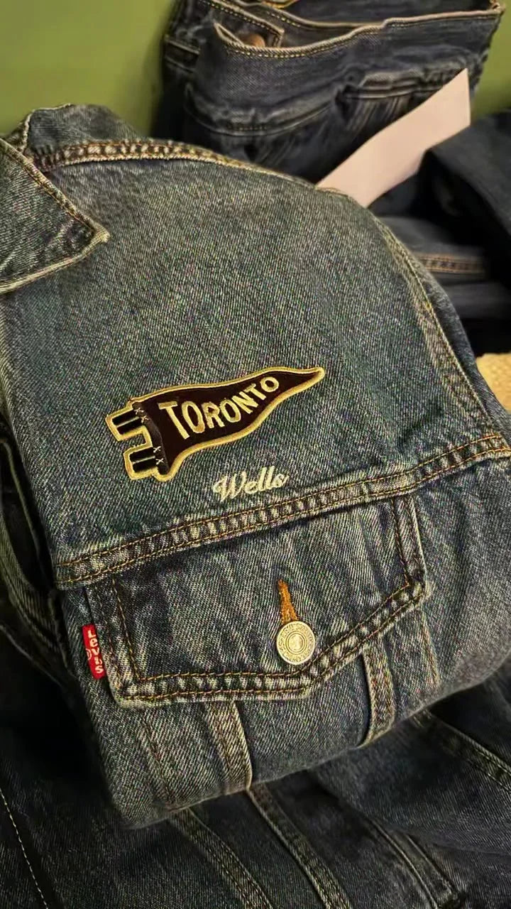 A denim jacket customized with patches at a watch party