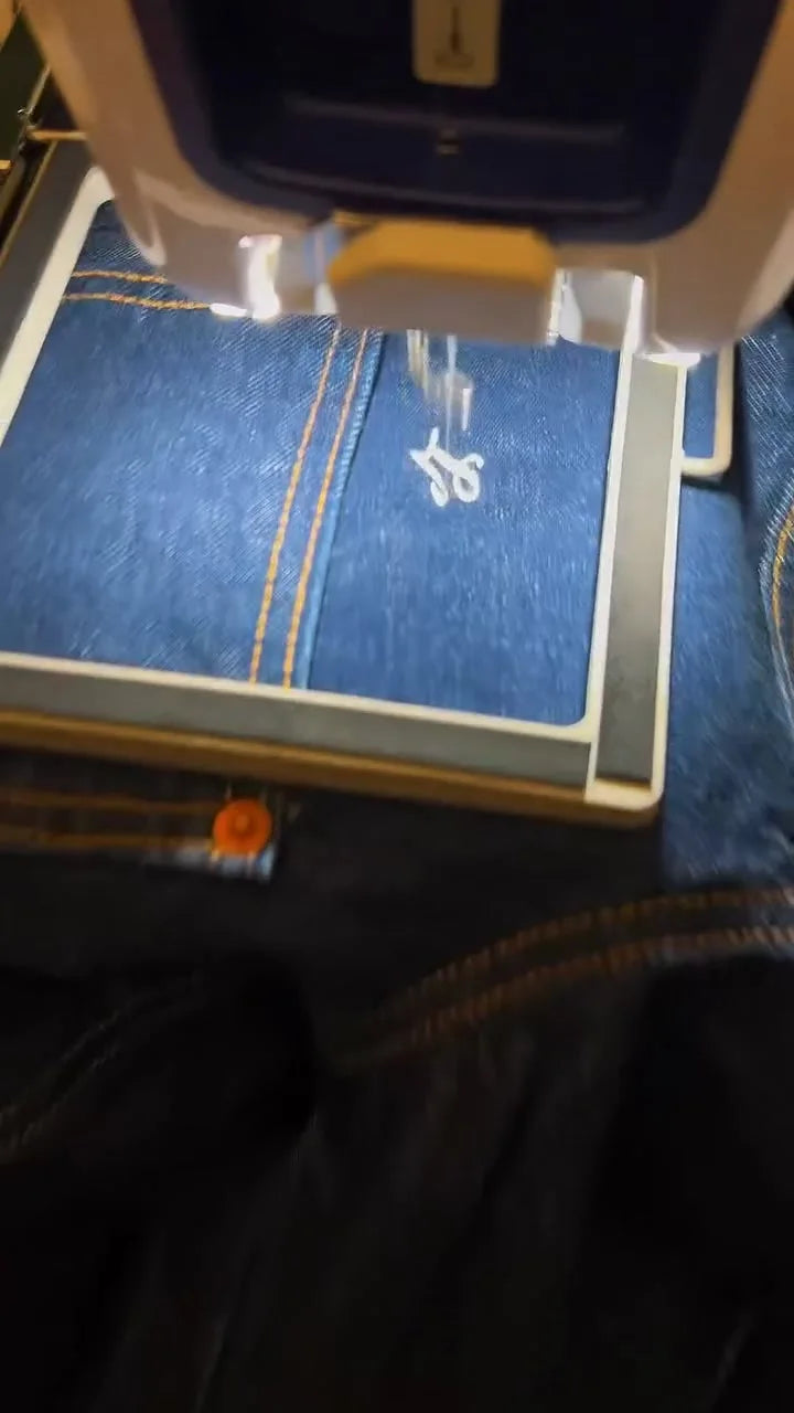 A denim jacket being customized live at a brand event