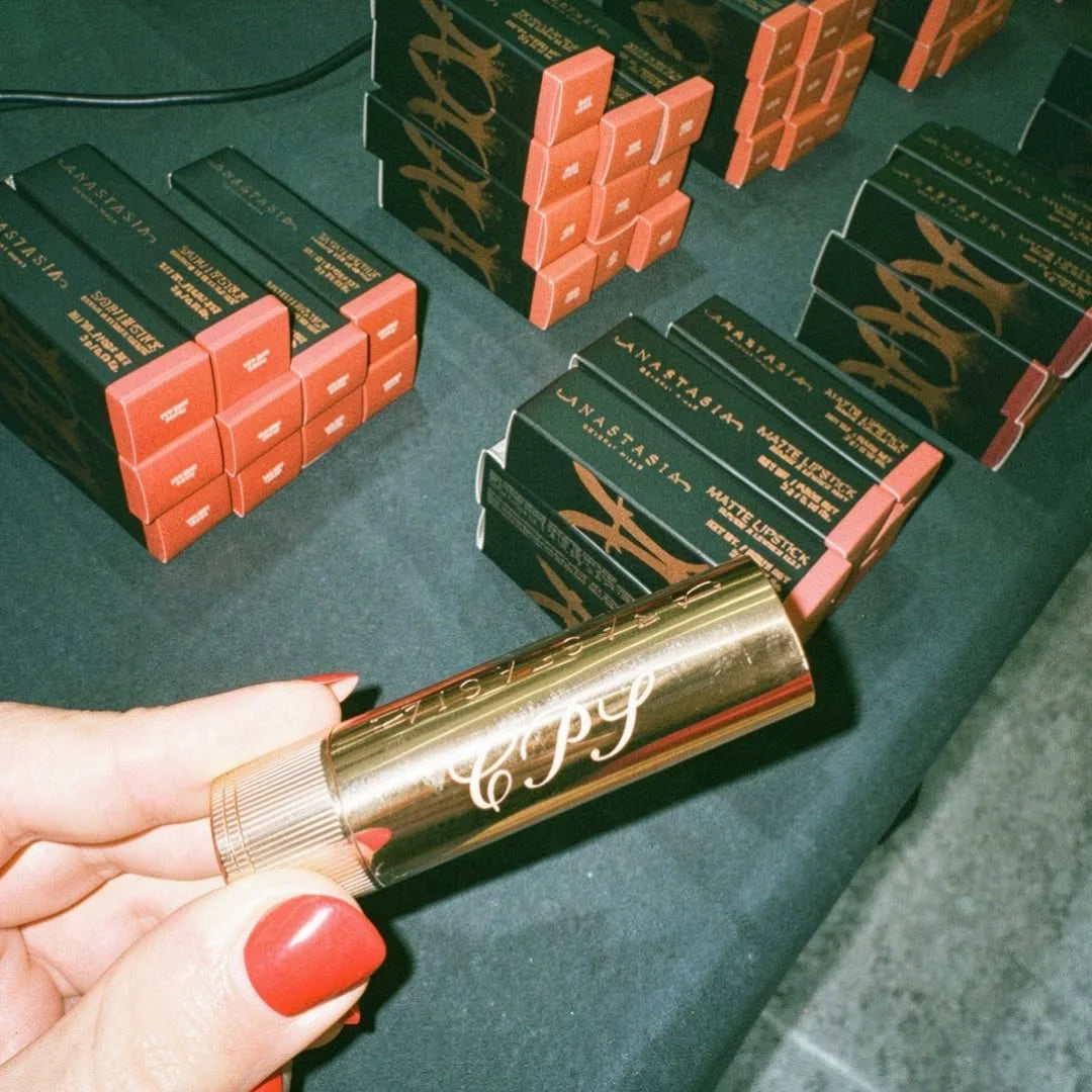 Hand holding an engraved Anastasia Beverly Hills lipstick
