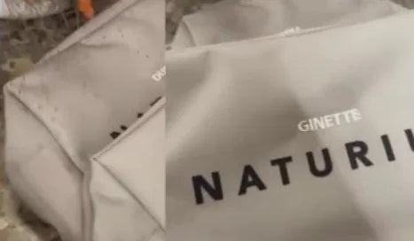 A tote bag embroidered live with personal text above the brand mark