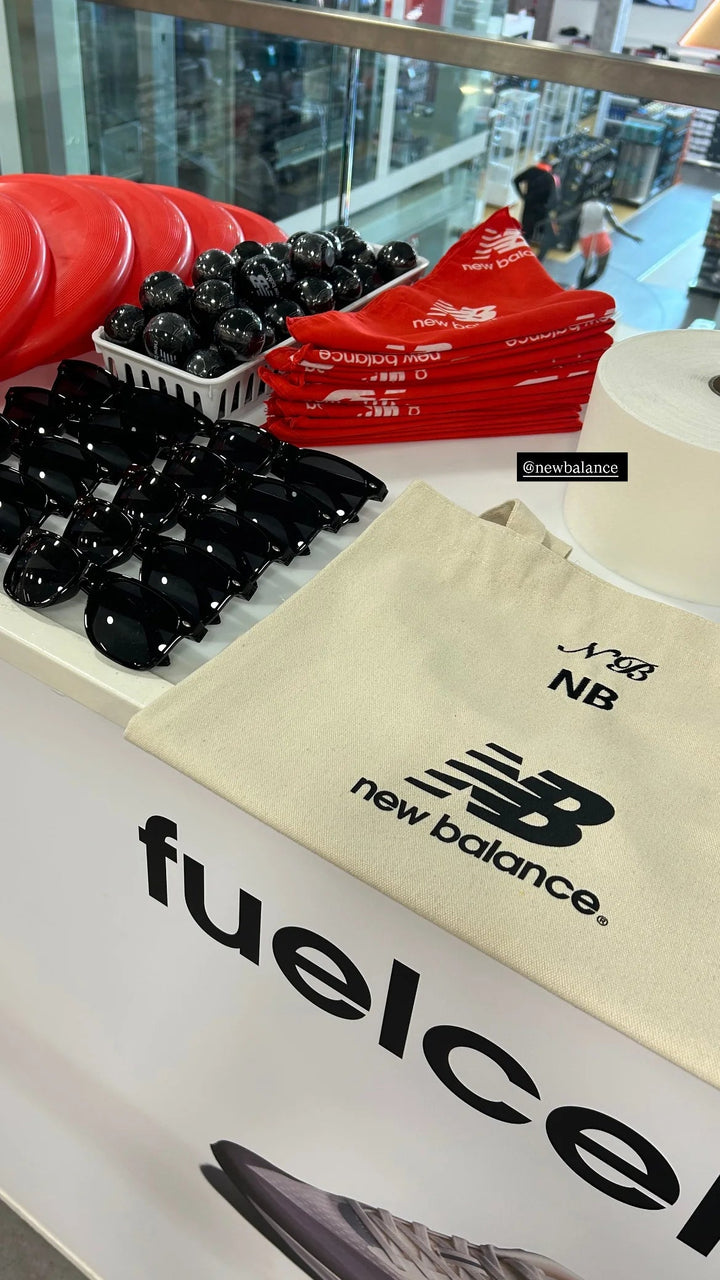 Personalized totes on a running-shoe launch display