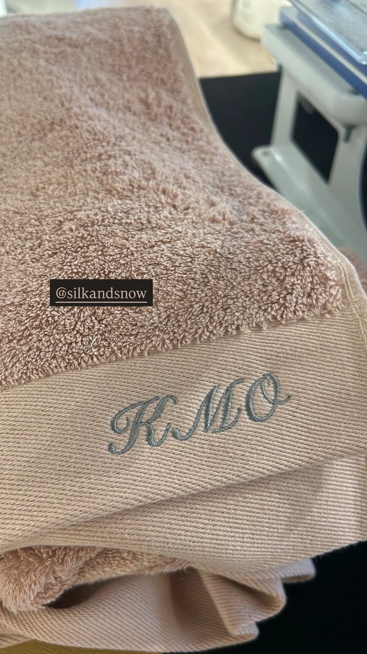 Towels being monogrammed in-store during a grand-opening weekend