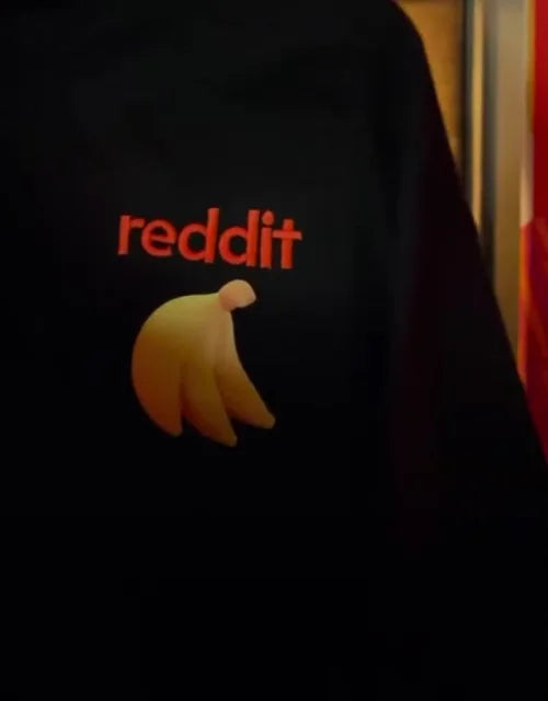 Black apparel displaying orange Reddit lettering and a yellow banana graphic.